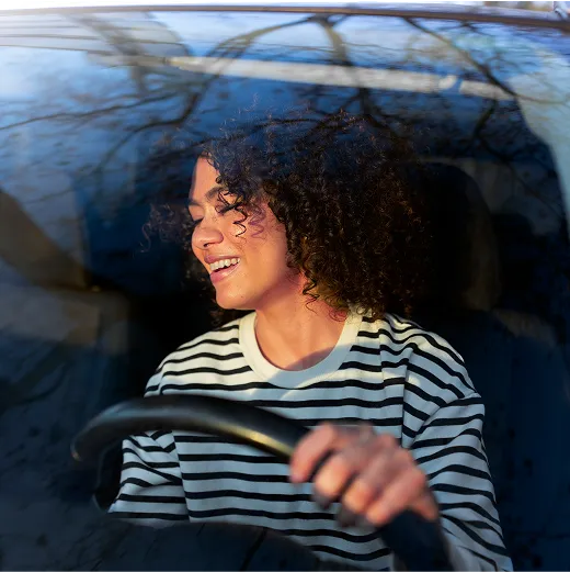 Happy woman in car